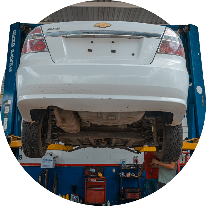 pexels-photo-4116170 A blue and orange car lift equipment lifting a white vehicle